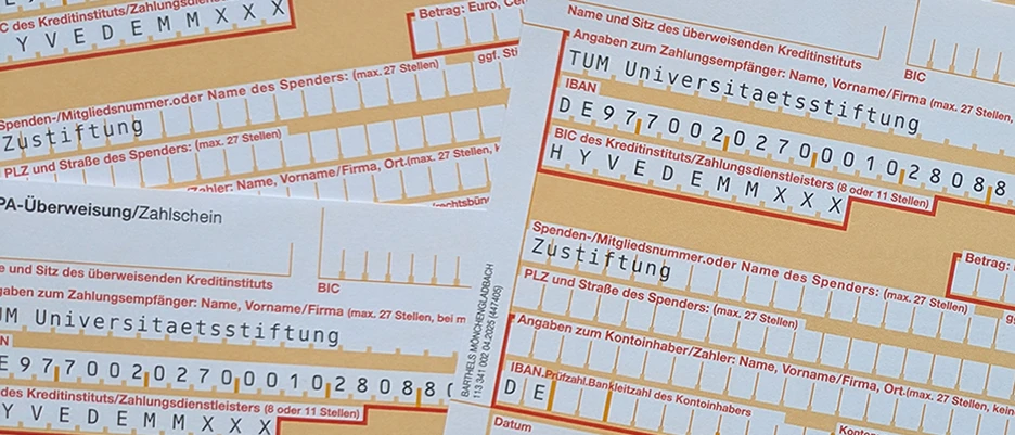 Symbolbild mit mehreren Überweisungsträgern auf denen TUM Universitätsstiftung eingetragen ist
