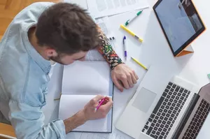 Student with notebook and tablet.